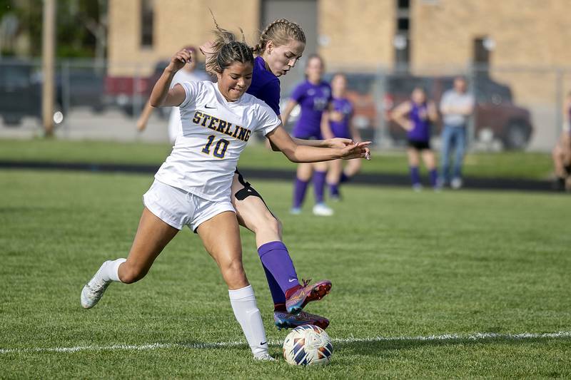 Sterling’s Aiesa Urrutia and Dixon’s Maggie Van Sickle fight for the ball Tuesday, May 9, 2023.
