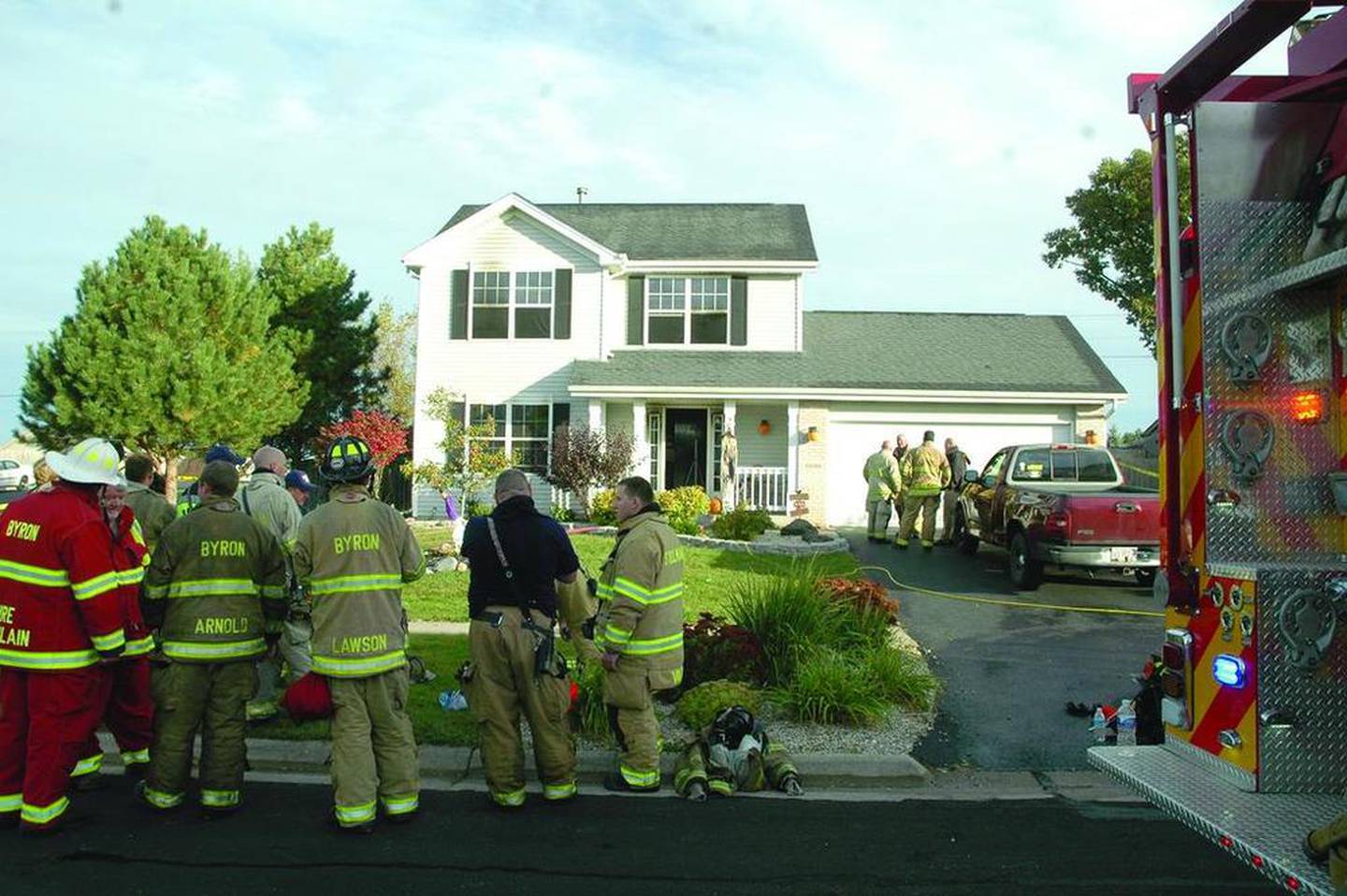 Byron firefighters stand outside of 2020 Silverthorn Drive on Oct. 19, 2016.
