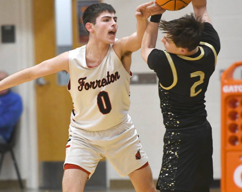 Forreston's Joseph Kolber reaches for the ball as Pecatonica's Karter Degner protects during a NUIC game on Wednesday, Feb. 11, 2026 at Forreston High School.