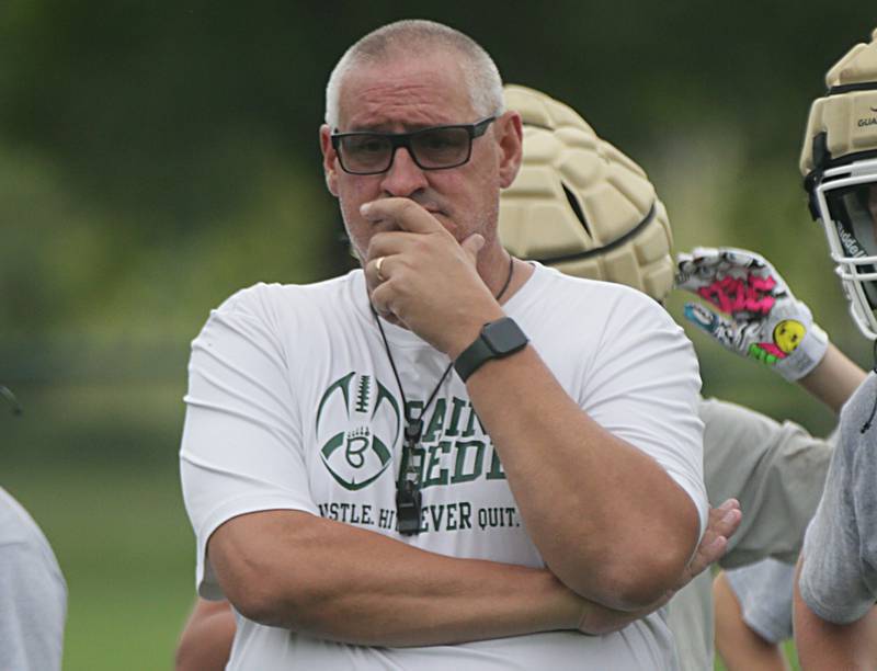 St. Bede football head coach Jim Eustice watches his team run plays during the first day of football practice at St. Bede Academy on Monday, Aug. 8, 2022 in Peru.