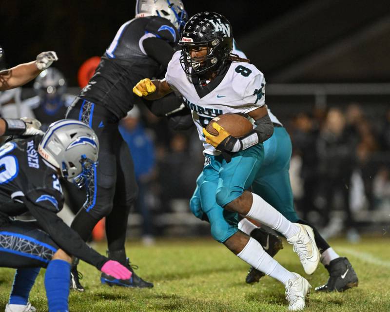 Woodstock North's Max Dennison looks for an opening early in the first quarter of their game against Kishwaukee River Conference and crosstown rival Woodstock on Friday, Oct. 25, 2024 at Woodstock H.S.