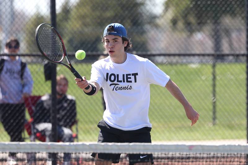 Joliet Township’s Paul Coffey returns a shot against Joliet Catholic’s Andy Munoz on Saturday, April 6, 2024 in Joliet.