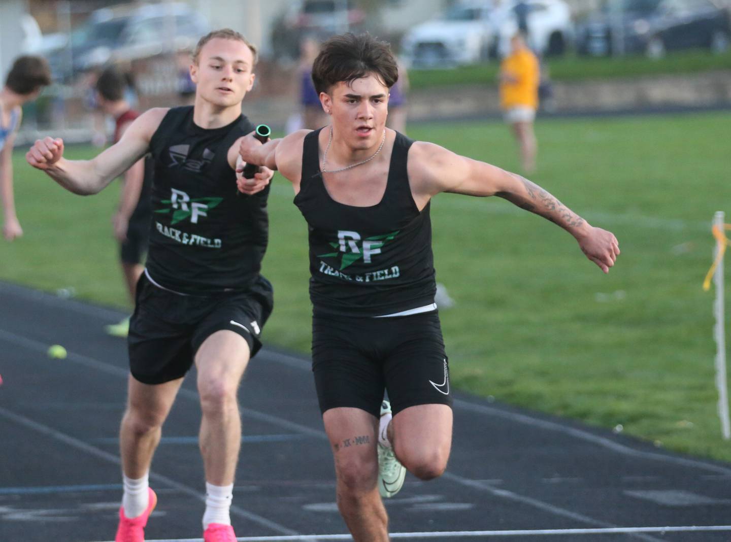 Rock Falls's Gavin Sands hands teammate Easton Canales the baton in the 4x200 meter relay during the Ferris Invitational on Monday, April 15, 2024 at Princeton High School.