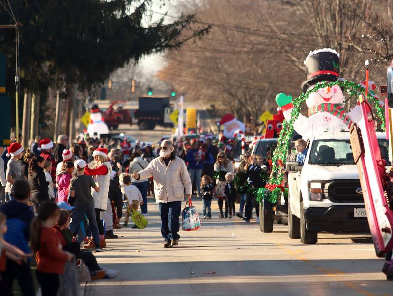 A parade makes its way along West Main Street as part of Merry Cary events Sunday, Dec. 8, 2024 in Cary.