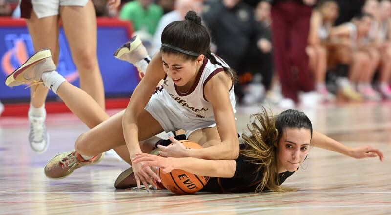St. Ignatius' Maliyah Miller, top, and Montini's Nikki Kerstein go to the floor for a loose ball during the IHSA Class 3A girls state basketball championship game at CEFCU Arena on Saturday, March 8, 2025 in Normal.