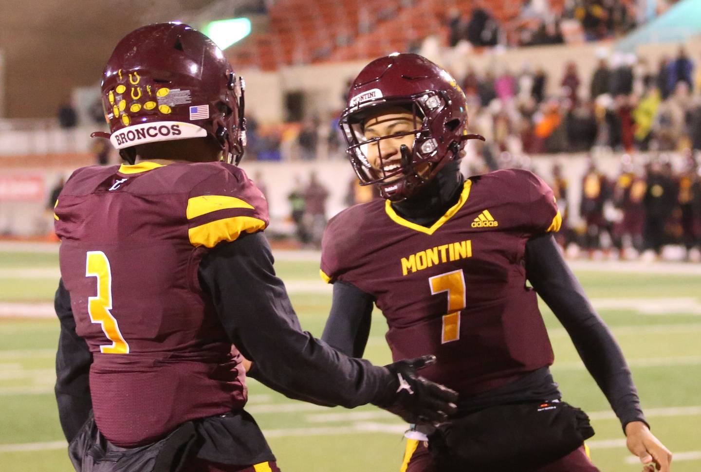 Montini quarterback Israel Abrams smiles as he congratulates teammate JoJo James after scoring a touchdown against Monticello during the Class 3A State football championship on Friday, Nov. 29, 2024 at Hancock Stadium in Normal.