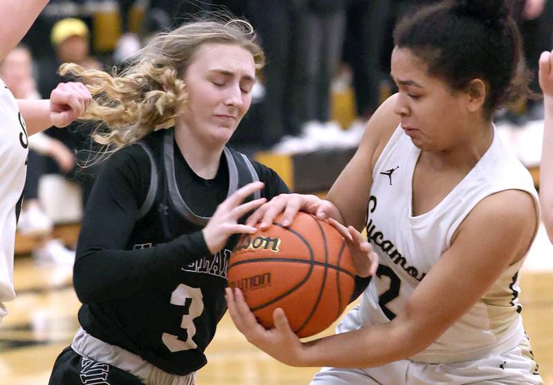 Kaneland's Alexis Schueler (left) and Sycamore's Monroe McGhee fight for possession during the Class 3A regional final game Friday, Feb. 17, 2023, at Sycamore High School.