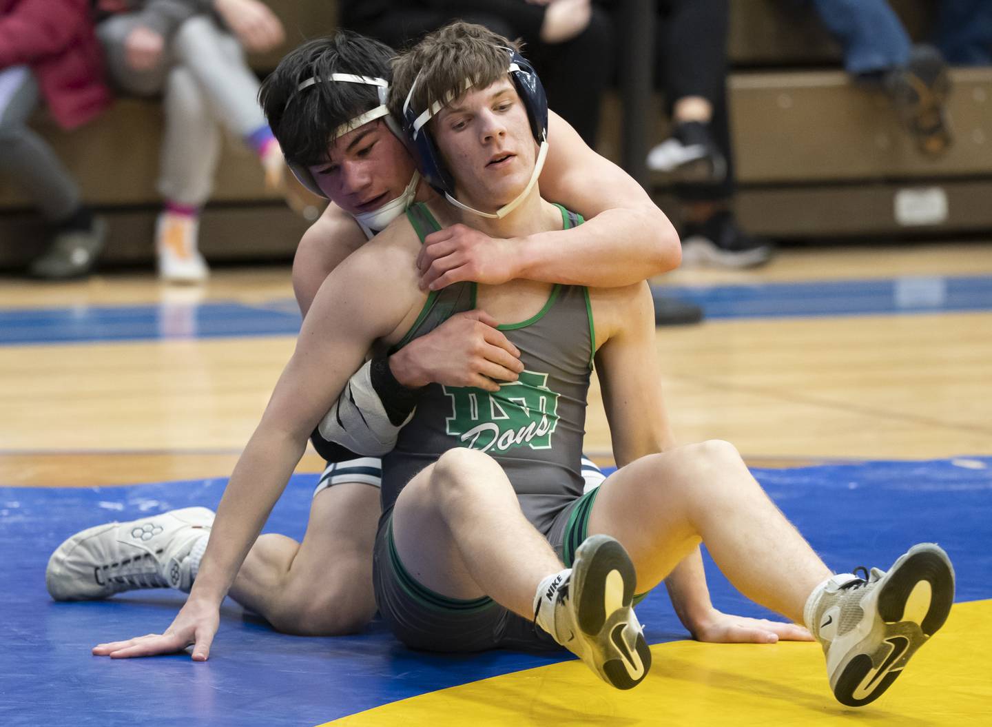 IC Catholic's Aidan Arnett, left, wrestles with Notre Dame's Jake Luczak in the 150 pound bout during the Class 2A Dual Team wrestling Sectional on Tuesday, February 25, 2025 at Wheeling High School. Ryan Rayburn for Shaw Local
