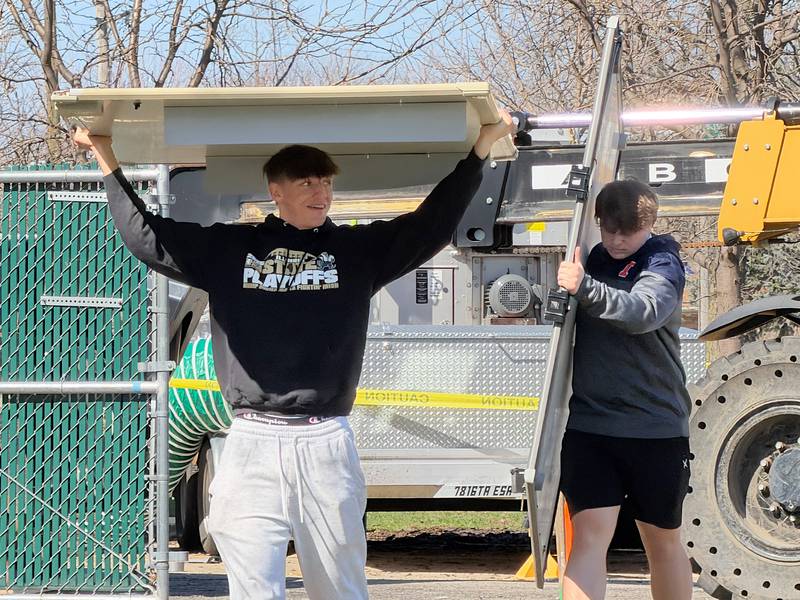 Bishop McNamara seniors Coen Demack, left, and Cale Hamilton remove damaged Smart Boards from McNamara's Kankakee site on Thursday, March 12, 2026. The pair were two of the scores of students and families that turned out last week to help clean up the school after it suffered significant damage in the severe storms that hit Kankakee County on Tuesday, March 10, 2026.
