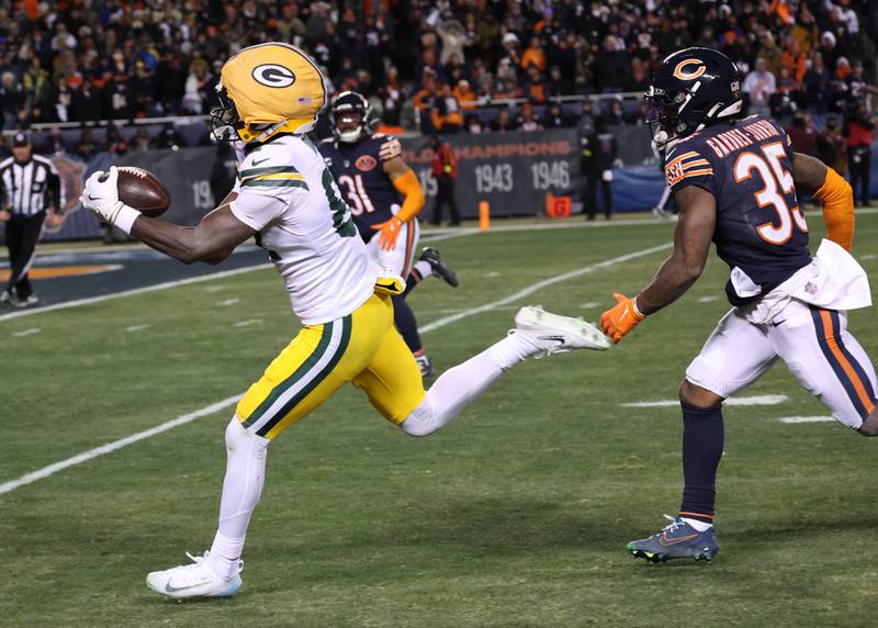 Green Bay Packers wide receiver Romeo Doubs hauls in a touchdown pass ahead of Chicago Bears safety C.J. Gardner-Johnson Saturday, December 20, 2025, during their game at Soldier Field in Chicago.