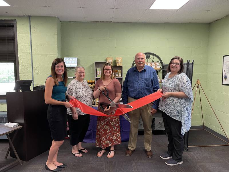 Courtney Levy, executive director of the Streator Chamber; Jeanne McMenamin, of the Streator Chamber; Elizabeth Gillette, owner of Arabella Remedies LLC; Streator City Manager David Plyman; and Amy Lambert, of the Small Business Development Center, participate in a ribbon cutting ceremony for Arabella Remedies LLC in the Streator Incubator.