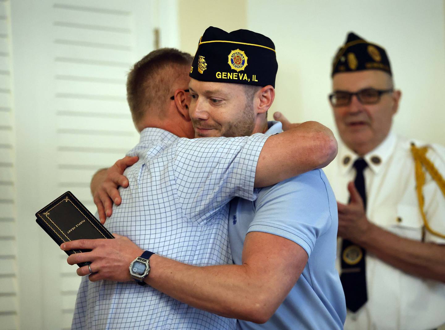 Scott Gorski, left, gives a big hug to his son Shawn Gorski after Illinois Treasurer Michael Frerichs returned a lost Purple Heart medal to the family during a ceremony Thursday, June 12, 2025 at the American Legion Post 75 in Geneva. World War II veteran Private First-Class Edward Gorski Jr. earned the Purple Heart medal while fighting to liberate Germany. Shawn also served in the Army.