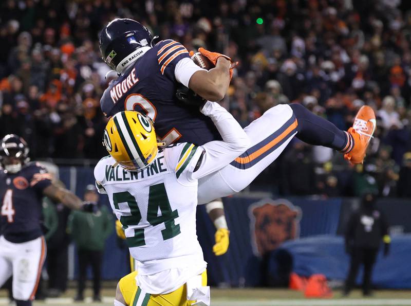 Chicago Bears wide receiver DJ Moore makes a catch in front of Green Bay Packers cornerback Carrington Valentine in overtime Saturday, December 20, 2025, during their game at Soldier Field in Chicago.