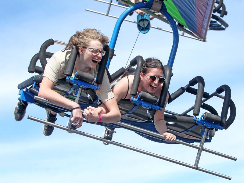 Dylan West, 17, and Yulissa Cardenas, 16, both of Wauconda ride the Cliff Hanger together during Wauconda Fest in Wauconda.  (6/26/22)