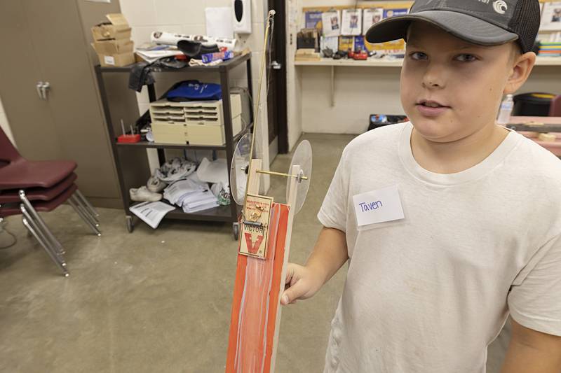 Taven Sturtz, 11, of Shannon shows off his award winning mousetrap car Thursday, July 13, 2023. Each member of the group made a mousetrap powered car then raced them during the camp.