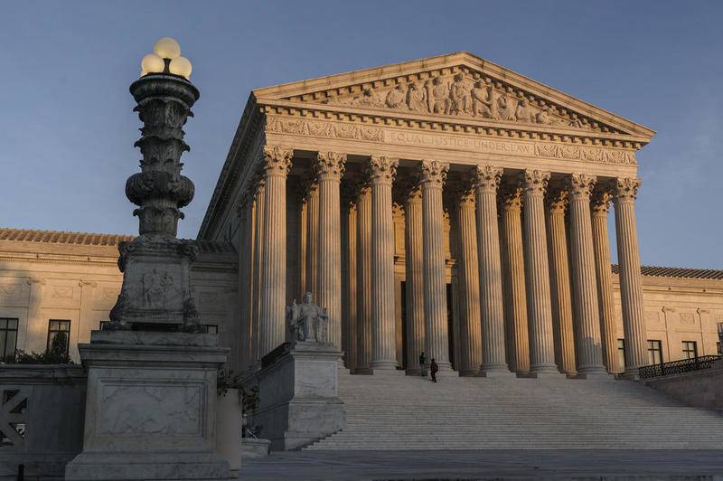 FILE - In this Nov. 6, 2020, file photo the Supreme Court is seen as sundown in Washington. The Supreme Court rejected on Dec. 11,a lawsuit backed by President Donald Trump to overturn Joe Biden's election victory, ending a desperate attempt to get legal issues rejected by state and federal judges before the nation's highest court. (AP Photo/J. Scott Applewhite, File)