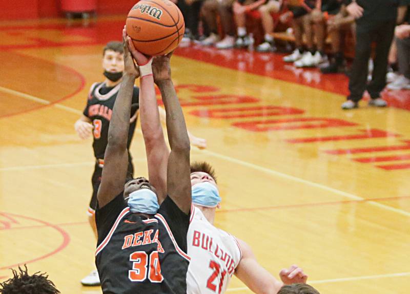DeKalb's Marlon King (30) and Streator's Tyler Luckey (21) battle for a rebound Saturday, Jan. 22, 2022, during the old rivals' meeting in Streator.