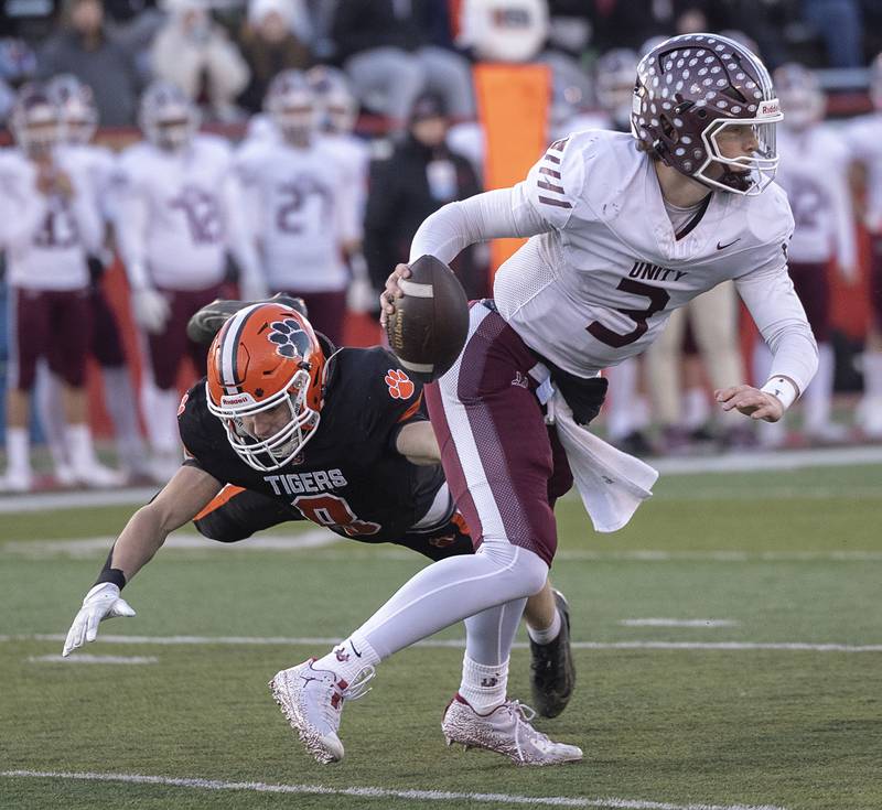 Tolono-Unity's Dane Eisenmenger scrambles away from Byron's William Julian Friday, Nov. 28, 2025, in the Class 3A football finals at Hancock Stadium at ISU.