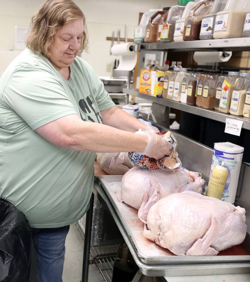 Amy Woods, kitchen manager for the Voluntary Action Center, unwraps turkeys Thursday, Nov. 17, 2022, at the facility in Sycamore. The turkeys will be part of the Thanksgiving meals that will be delivered. The Thanksgiving meals were payed for through a donation from the family of Don "Tank" Anderson. VAC delivers meals to the homebound and elderly along with providing transportation options.