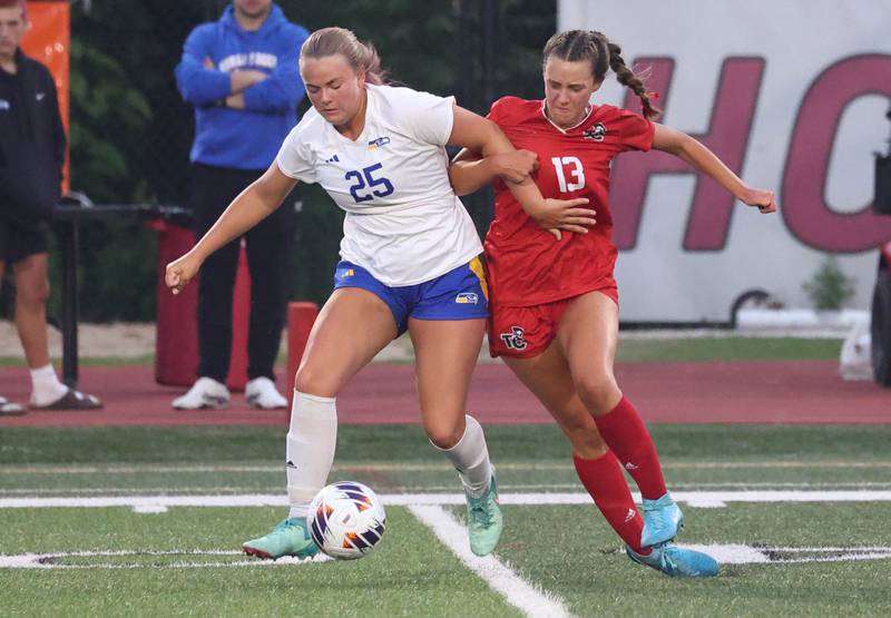 Johnsburg's Jacquelyn Douglas (left) tries to hold off Timothy Christian's Mackenzie Laslo Thursday, June 5, 2025, during their IHSA Class 1A state semifinal at North Central College in Naperville.