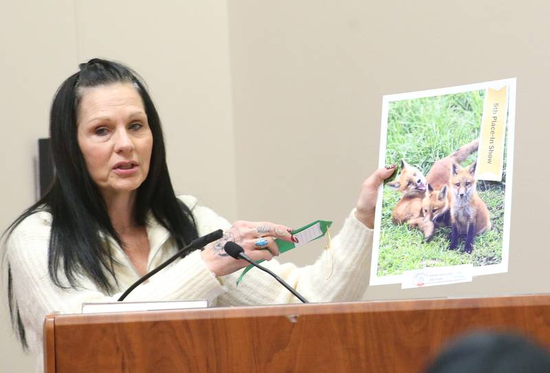 Kathy Buckley holds her 5th place in show photo of two foxes during the Starved Rock Photography Show awards on Saturday, Jan. 4, 2024 at the Starved Rock Visitors Center.