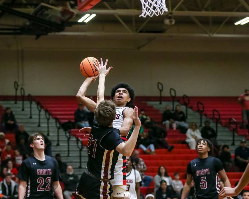Bolingbrook's Braden Pettigrew (1) puts up a contested shot during their basketball game between Plainfield North at Bolingbrook, Friday Dec 13, 2024 in Bolingbrook.