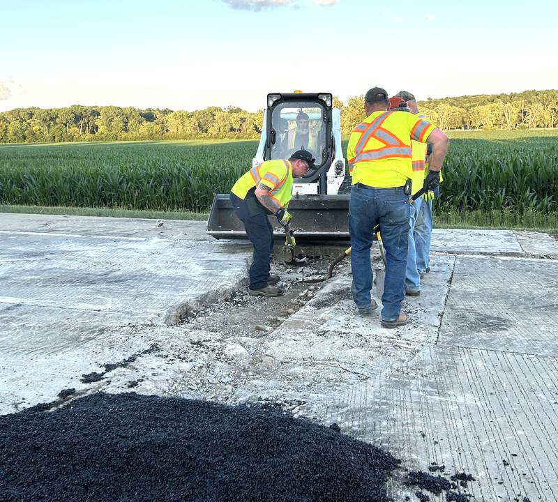 A crew from the Illinois Department of Transportation repairs one of two pavement blowouts on Illinois Route 2 Tuesday evening, July 1, 2025. The state highway was closed between Oregon and Byron as crews patched the roadway. This blowout was just north of Silver Ridge Golf Course. Another was located further north near the intersection with Town Line Road.