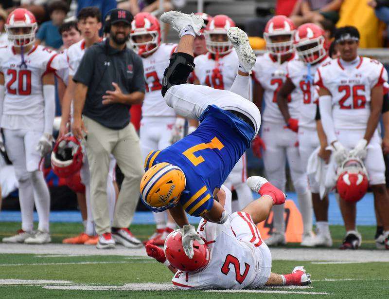 Lyons Township’s Brady Rusk (7) is upended by Hinsdale Central’s Patrick Connors (2) during a game on September 20, 2025 at Lyons Township High School in LaGrange.