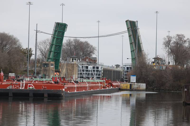 A barge passes through the Brandon Road Lock and Dam on Wednesday, Dec. 6, 2023 in Joliet. The U.S. Army Corps of Engineers plan to extend the guide walls and include deterrents to prevent upstream movement of invasive carp and other unwanted aquatic species.