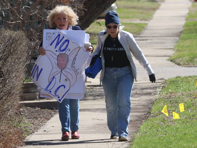 Protesters Mary Mickow and Marybeth Bouchard of Princeton, walk to the No Kings rally on Saturday, March 28, 2026 at Rotary Park in Princeton.