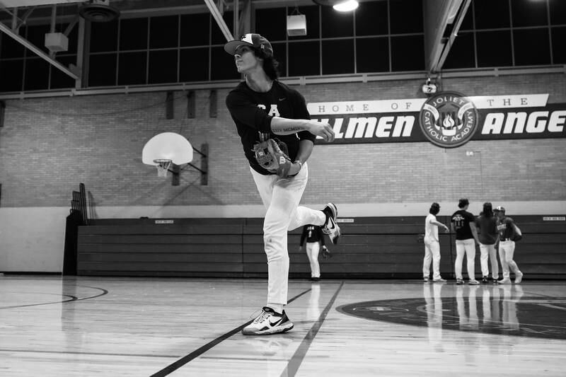 Joliet Catholic’s Aidan Hayse, a Tennessee commit, works on pick off moves indoors after their game was rescheduled due to weather on Tuesday, March 14th, 2023 in Joliet.