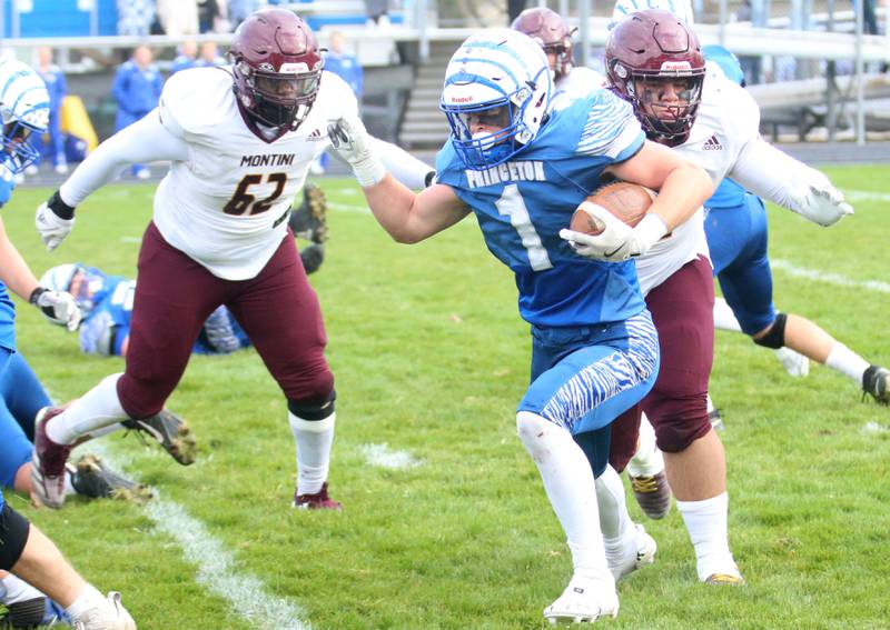 Princeton's Casey Etheridge runs the ball as Montini Catholic's Douglas Mattiuz wraps him up during the Class 3A quarterfinal game on Saturday, Nov. 16, 2024 at Bryant Field in Princeton.