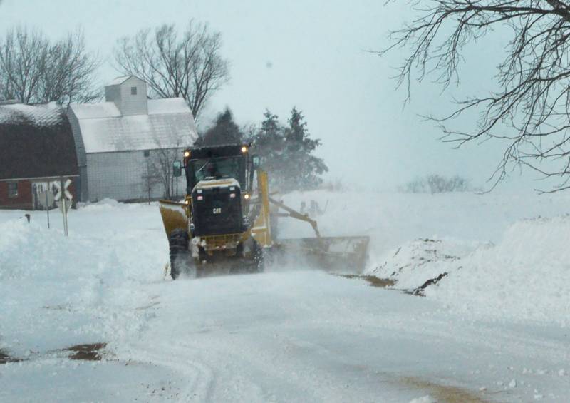 A motor grader plows out a rural road east of Polo on Monday, Jan. 15, 2024. Residents and workers were still digging out from the weekend winter storm that dropped between 10-12 inches of snow across the region, followed by wind gusts and below zero temperatures