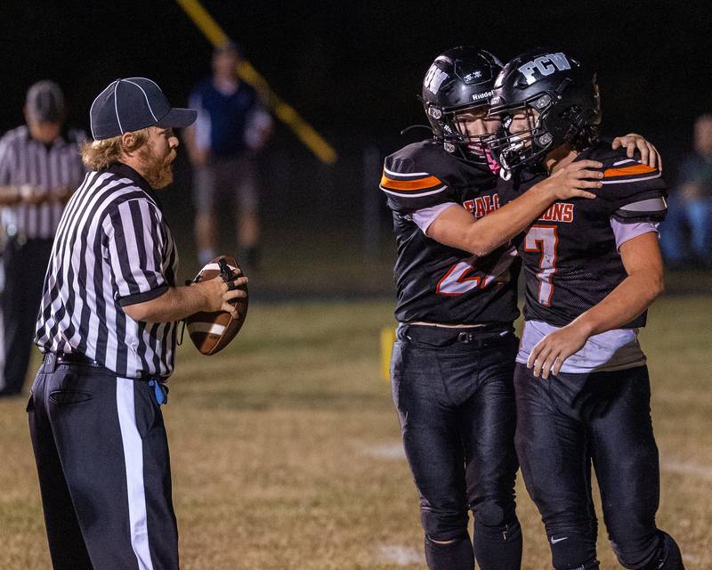 Emmett Horaney (2) of FCW hugs teammate Leelynd Durbin (7) after he scored a first down on Friday, Sept. 26, 2025 at Woodland High School in Streator.
