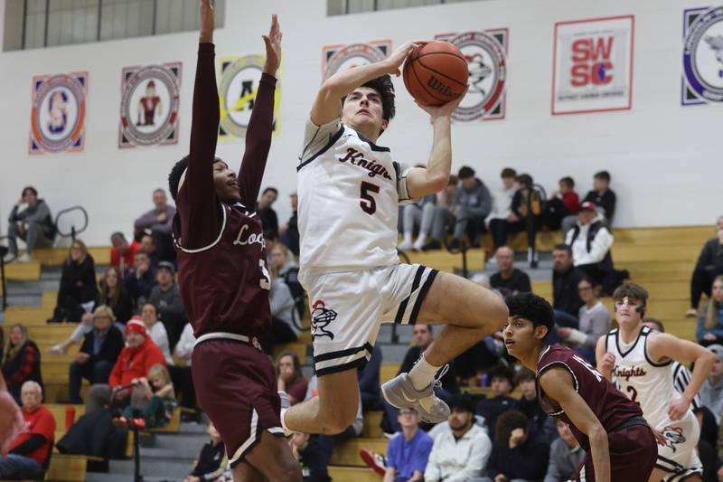 Lincoln-Way Central’s Ben McLaughlin finesse a shot against Lockport on Tuesday, Jan. 23rd, 2024 in New Lenox.