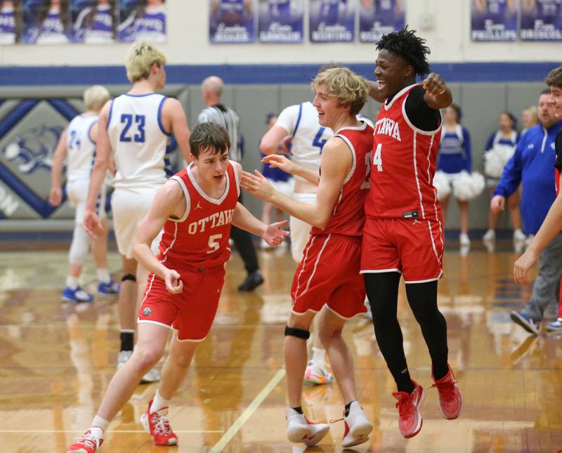 Ottawa's Kyler Araujo reacts with teammates Lucas Goetz and Keevon Peterson after scoring a half-court buzzer beater shot against Princeton to end the first half on Monday, Feb. 5, 2024 at Prouty Gym.