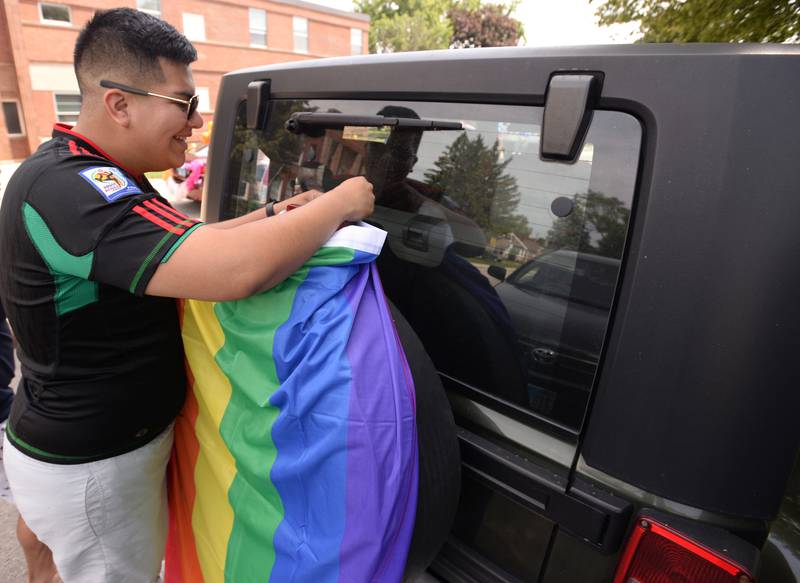 People including Antonio Gallegos of Berwyn decorate their vehicles for the Berwyn Pride Parade held Saturday June 15, 2024.