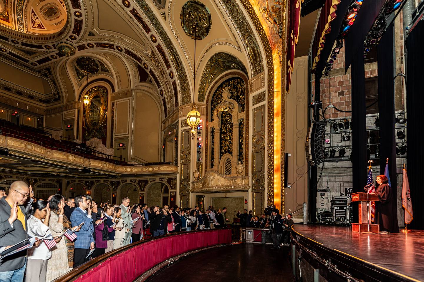 Honorable Laura K. McNally, U.S. District Court for the Northern District of Illinois, administers the Oath of Allegiance during the Naturalization Ceremony at Rialto Square Theatre in Joliet on April 17, 2025.