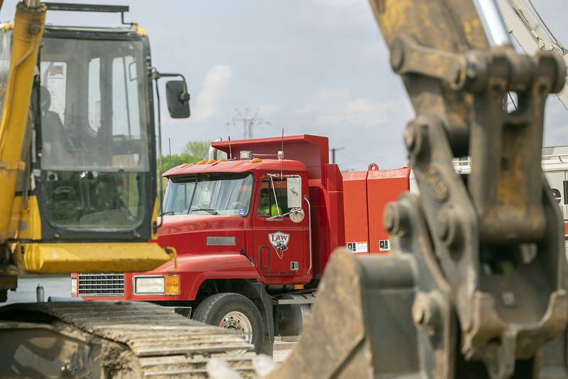 Heavy trucks move through the work site Tuesday, May 13, 2025, at Project Rock in Dixon.