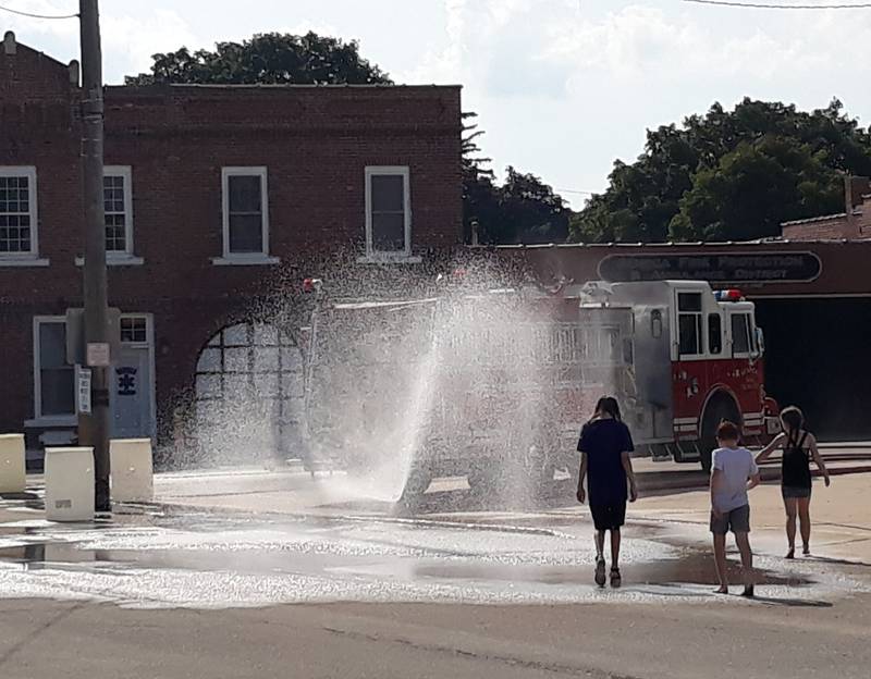 Children play in water set up by the Seneca Fire Department during the Shipyard Days car show Saturday, Aug. 6, 2022.