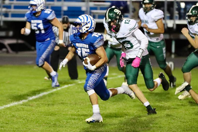 Princeton's Augie Christiansen races past St. Bede's Ben Wallace for a touchdown Friday Night at Bryant Field. The Tigers won 56-7.