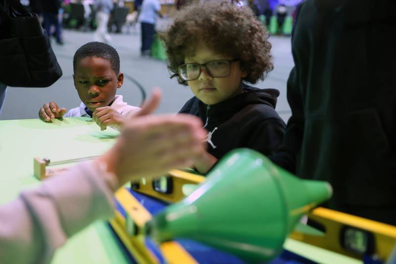 Kankakee third-grader Lazaire Mallett, left, and fourth-grader Malcolm Bulger observe a science experiment during the Impossible Science event at the Kankakee First Church of the Nazarene on May 5, 2026.
