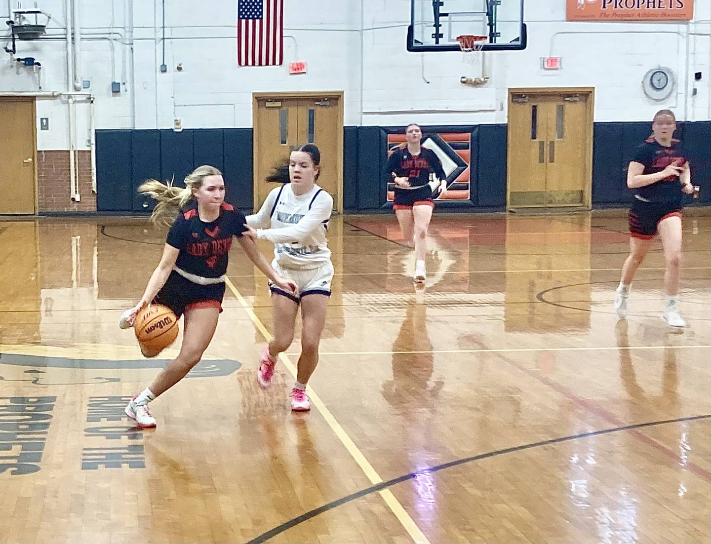 Hall's Charlie Pellegrini drives against Monmouth-Roseville at Prophetstown Tuesday night. The Red Devils won 57-39 to finish the Warkins Tournament at 3-1.