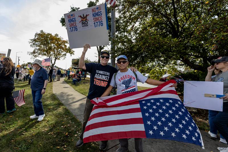 Dan Campbell and Saulo De Leon pose for a photo during the No Kings Protest at Mall Loop Drive in Joliet on Oct. 18, 2025.