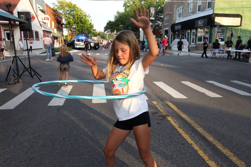 Esme Graybill, 8, of Wauconda plays with a hula hoop during National Night Out on Main Street on Tuesday, August 1st in Wauconda.  
Photo by Candace H. Johnson for Shaw Local News Network.