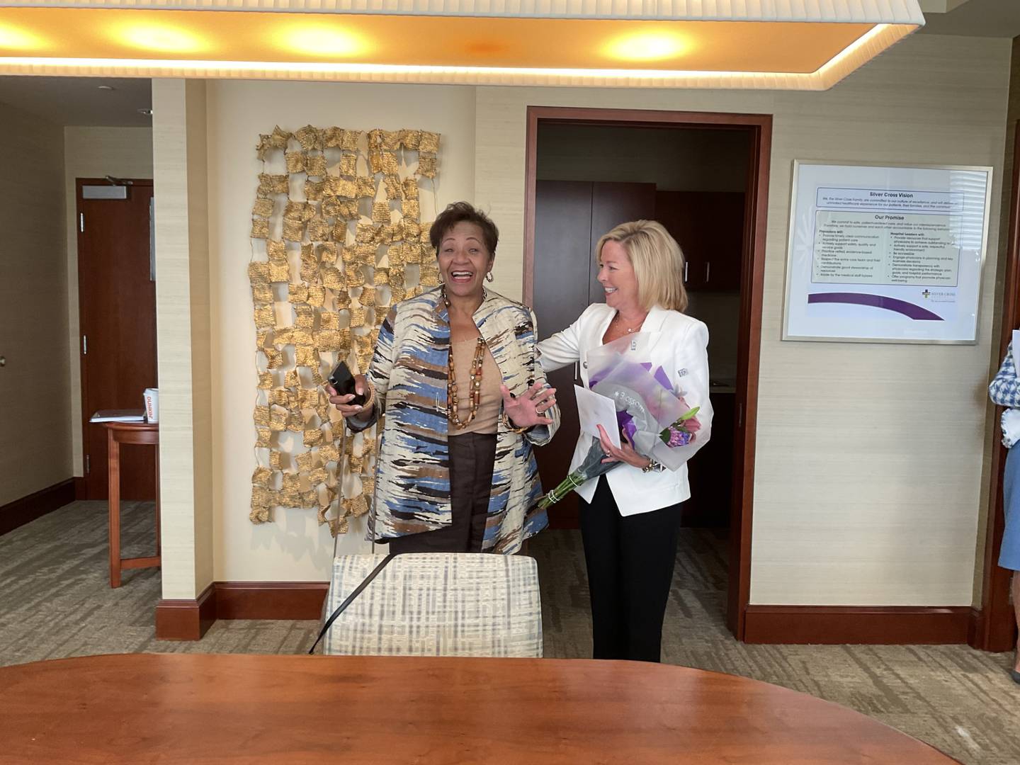 Denise Winfrey, Will County board commissioner for District 6 in Joliet (left) never expected to hear she was the 2023 recipient of The ATHENA Award when Silver Cross Hospital’s president and chief executive officer Ruth Colby called Winfrey to her office. Jen Howard, president of the Joliet Region Chamber of Commerce & Industry, (right) shares the news with Winfrey.