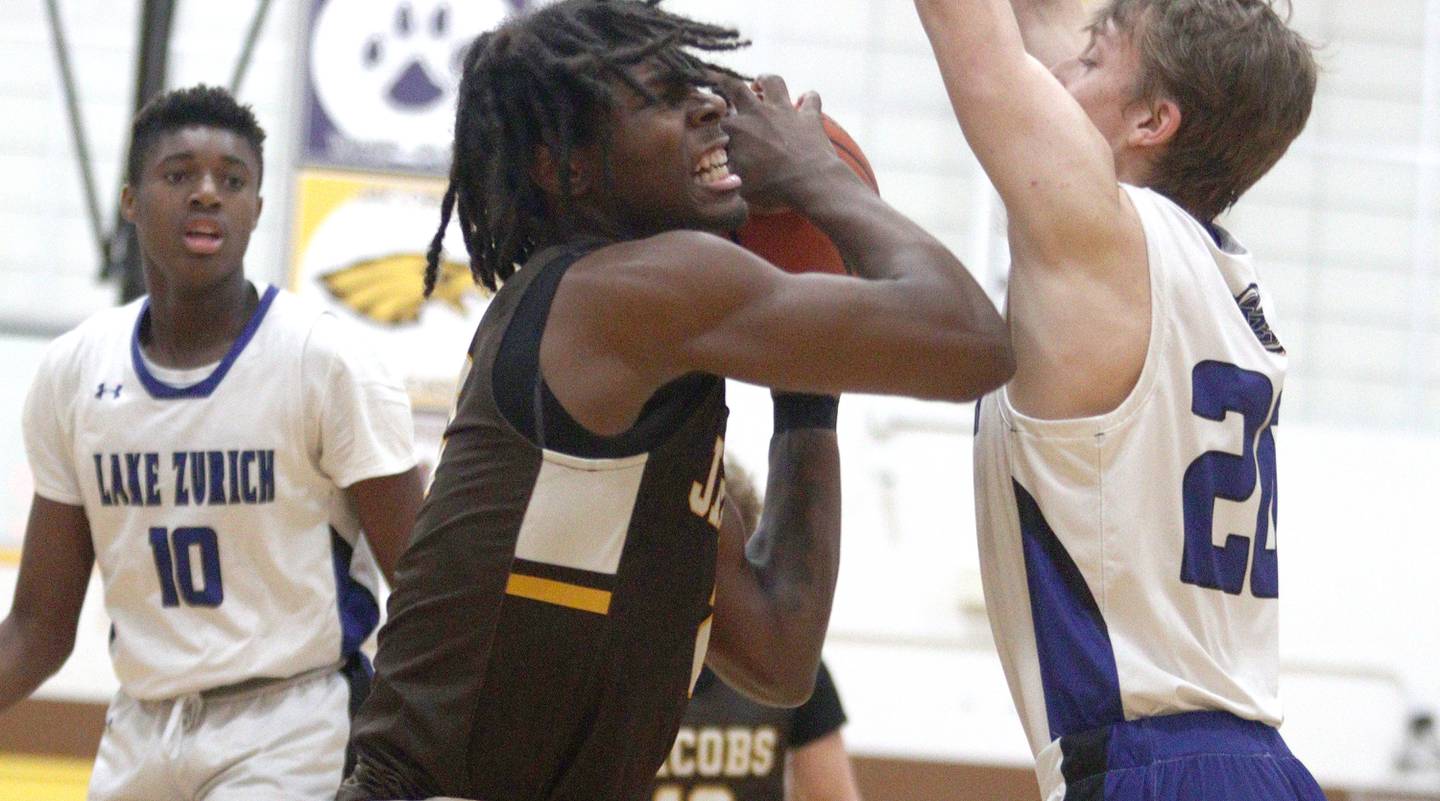 Jacobs’  Treval Howard works under the hoop against Lake Zurich in Hinkle Holiday Classic boys basketball tournament game action at Jacobs High School Tuesday.