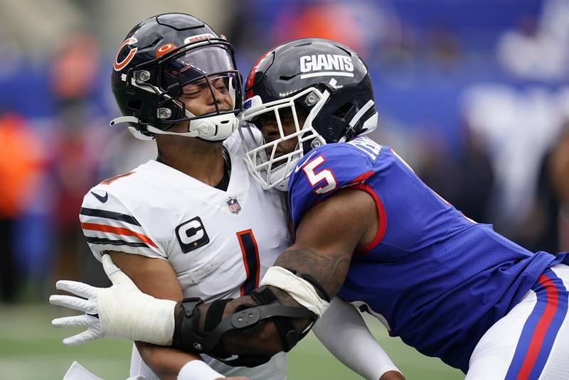 Chicago Bears quarterback Justin Fields (1) takes a hit from New York Giants defensive end Kayvon Thibodeaux (5) during the second quarter of an NFL football game, Sunday, Oct. 2, 2022, in East Rutherford, N.J. (AP Photo/Seth Wenig)