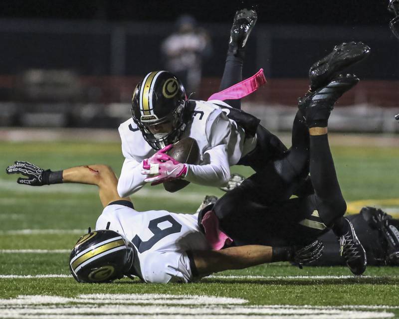 Glenbard North's Kayden Smith (3) dives for an interception off of a tipped ball during Class 7A first round football game between Glenbard North at Yorkville. Friday, Oct 31, 2025 in Yorkville.