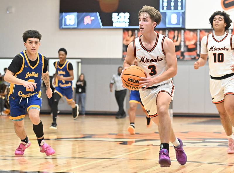 Minooka's Kevin Bisbee (3) looks to pass the ball  during a conference game against on Friday, Jan. 10, 2025, at Minooka.